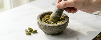 Grinding cardamom pods fresh immediately before use — never pre-grind and store