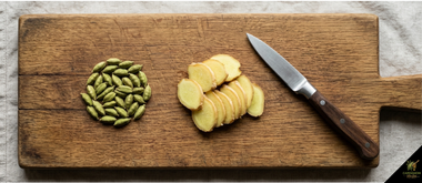 Slicing fresh ginger root and crushing green cardamom pods for digestive tea