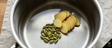 Ginger slices added to cold water in saucepan before heating — cold-start extraction method