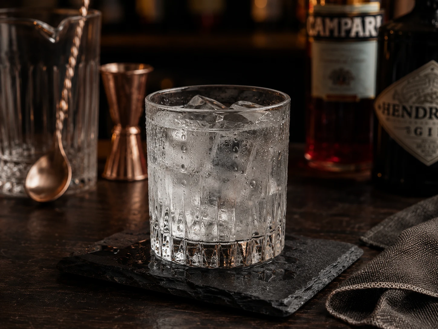 Chilling rocks glass with ice water before making a negroni
